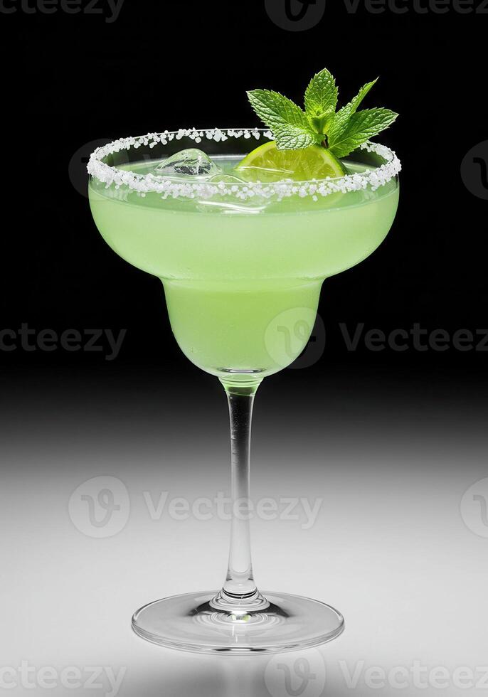 A vibrant margarita cocktail is garnished with fresh mint and lime. photo