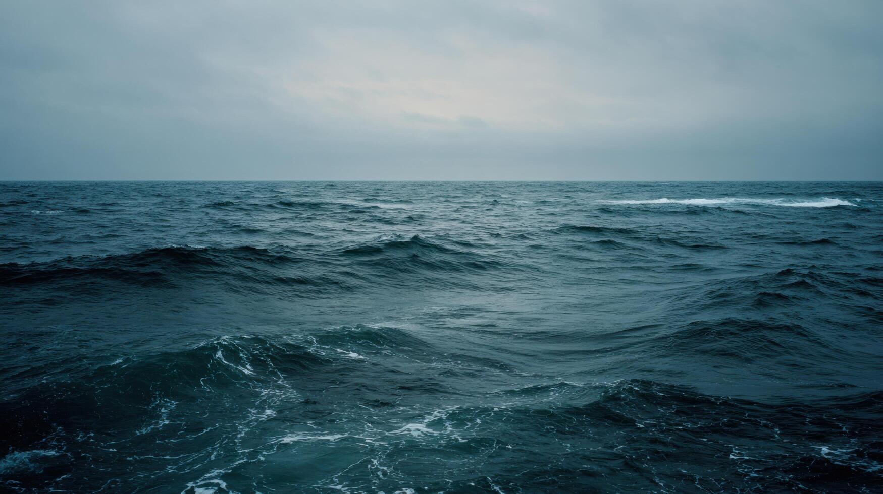 A Calm And Wide Open Ocean Under An Overcast Sky photo