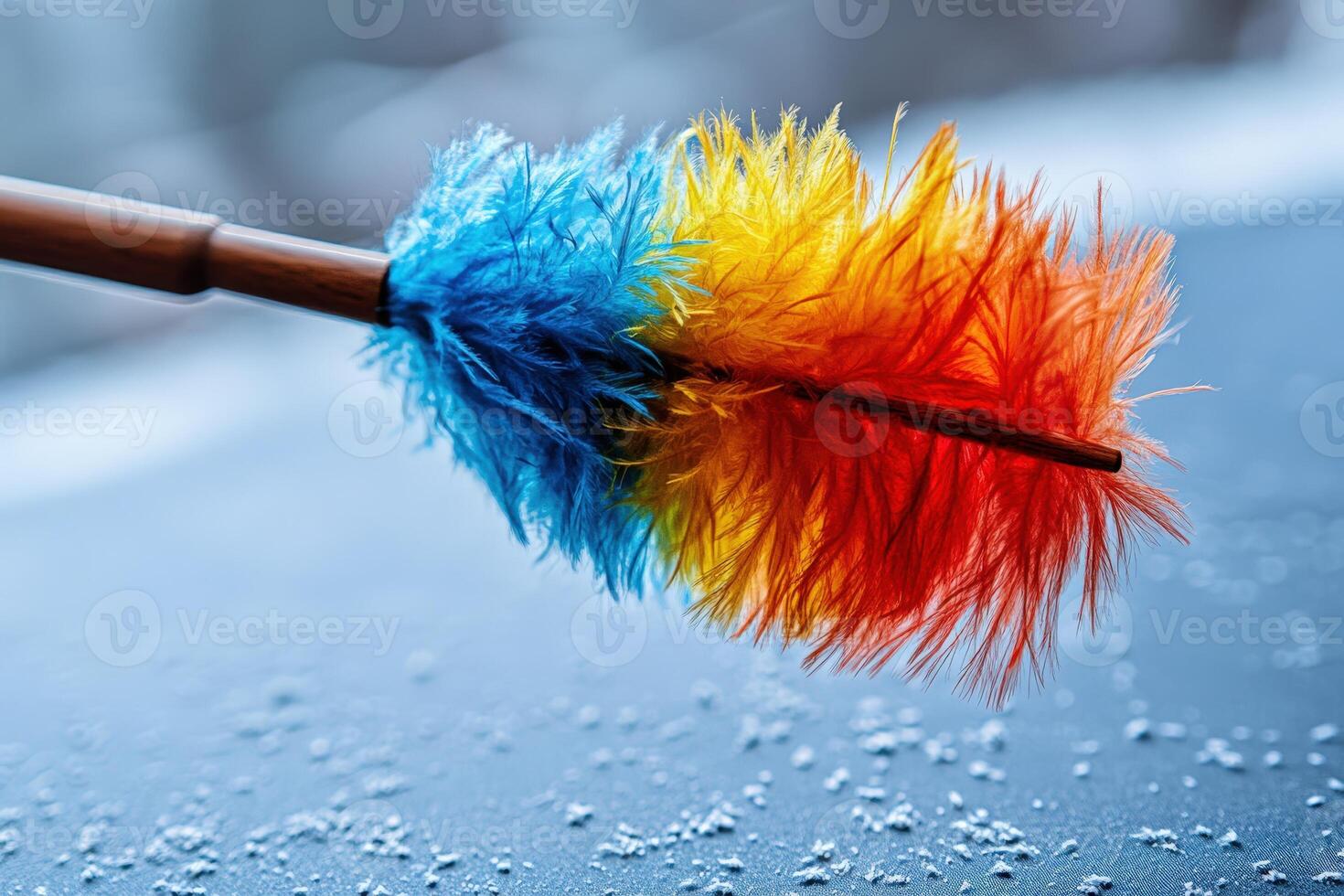 A colorful feather brush is being used to clean the windshield photo