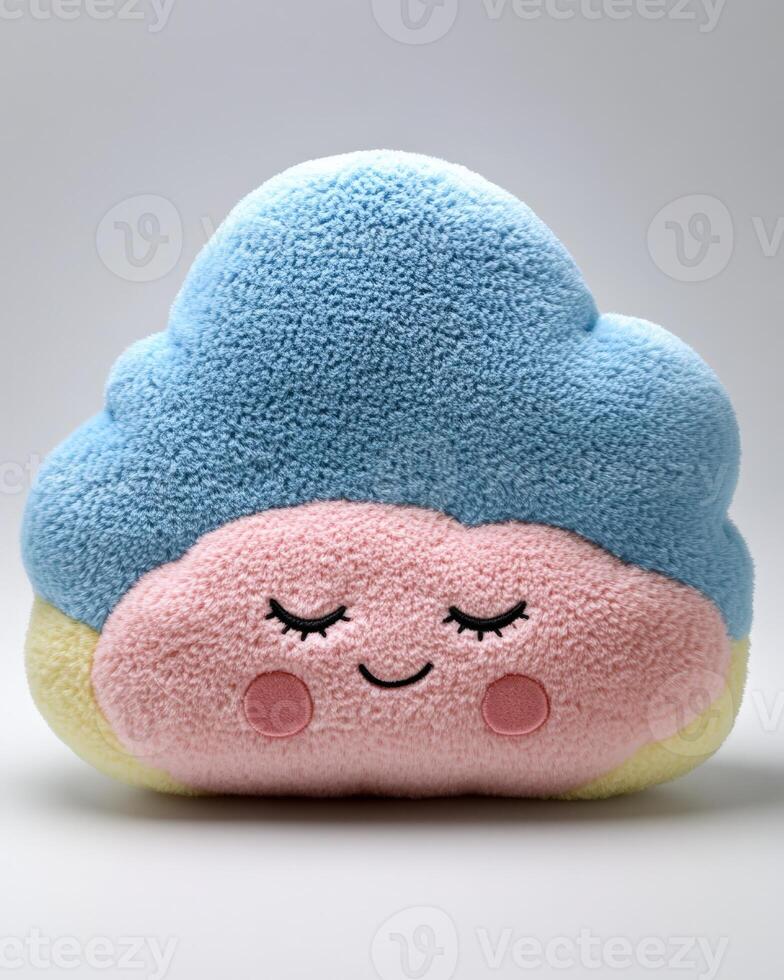 A blue and pink cloud shaped pillow with eyes closed photo