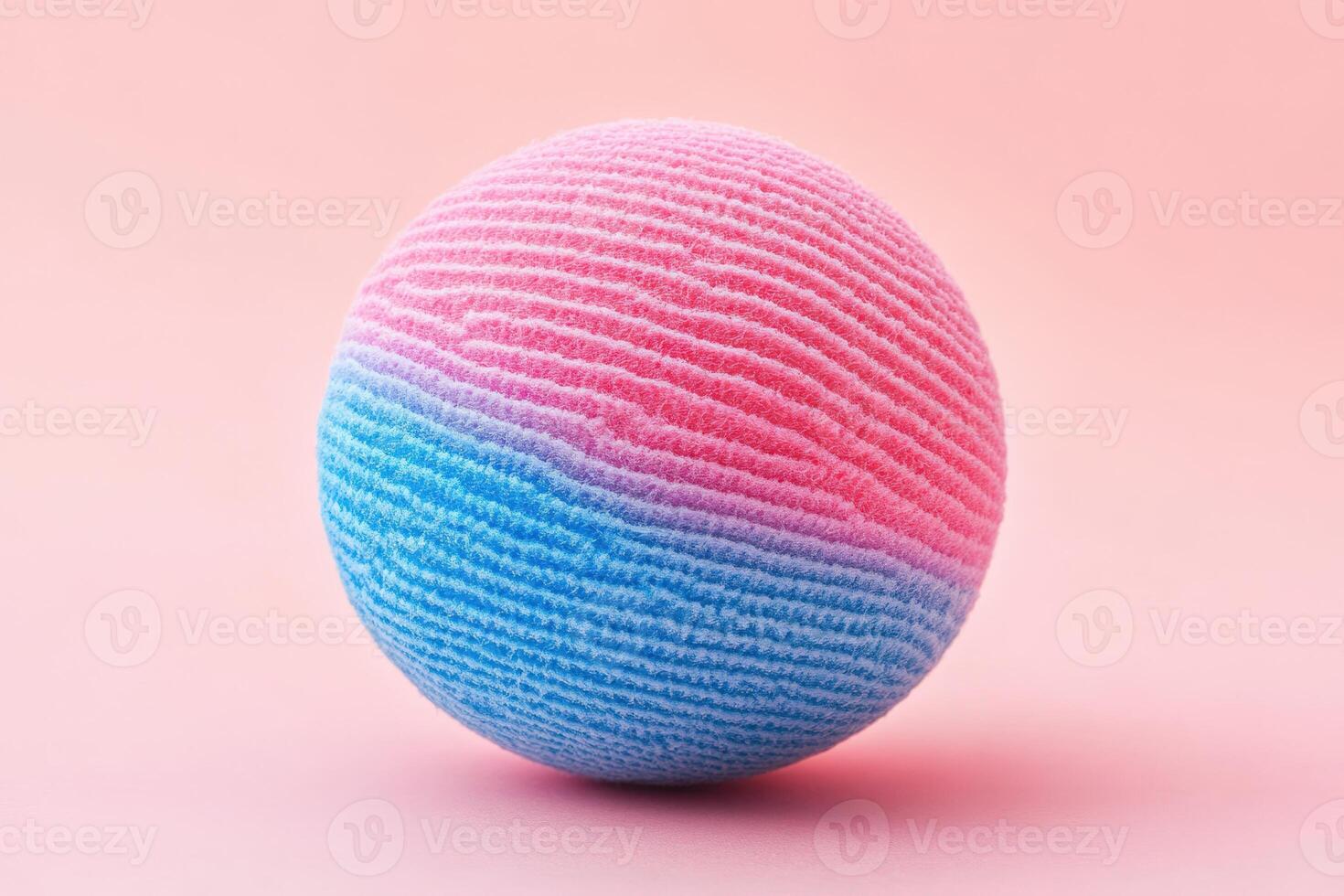 A pink and blue sponge ball on a pink background photo