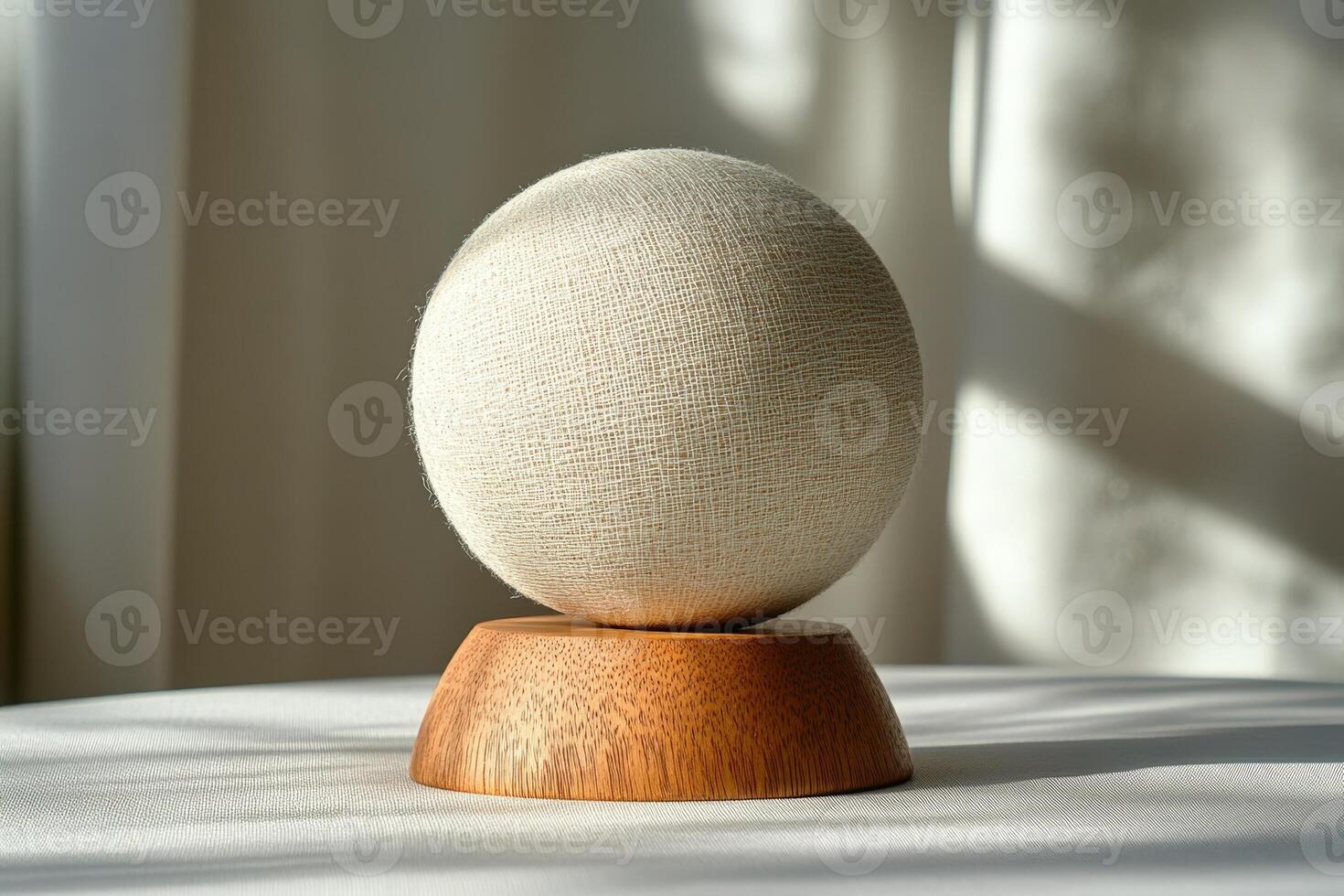 A white egg sitting on a wooden stand photo