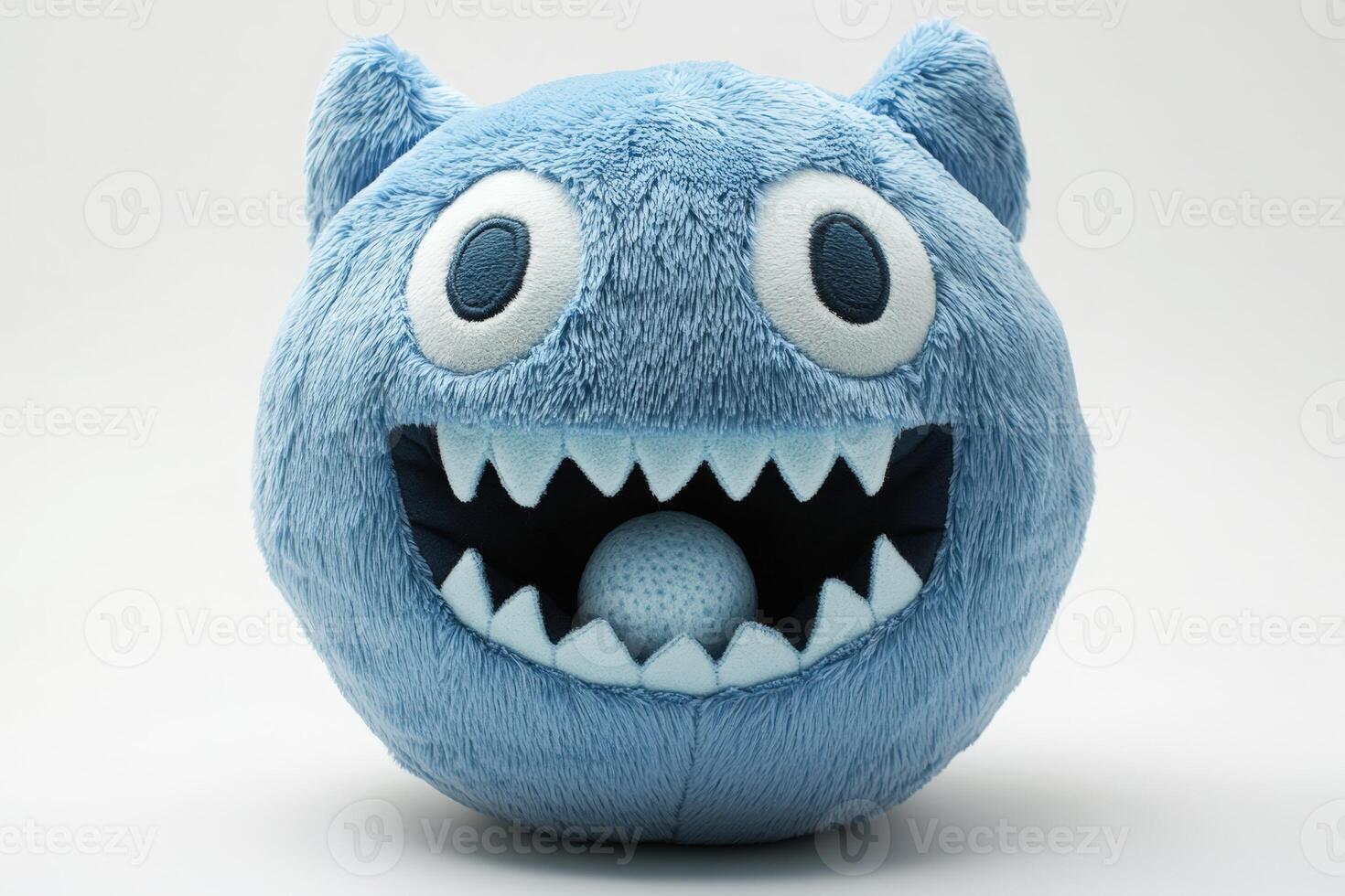 A blue monster plush toy with teeth and eyes photo