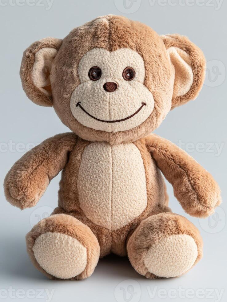 A stuffed monkey is sitting on a white background photo