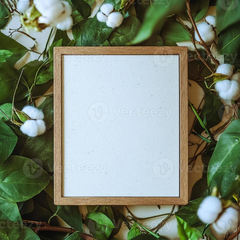 Empty Frame on Green Leaves and Cotton photo