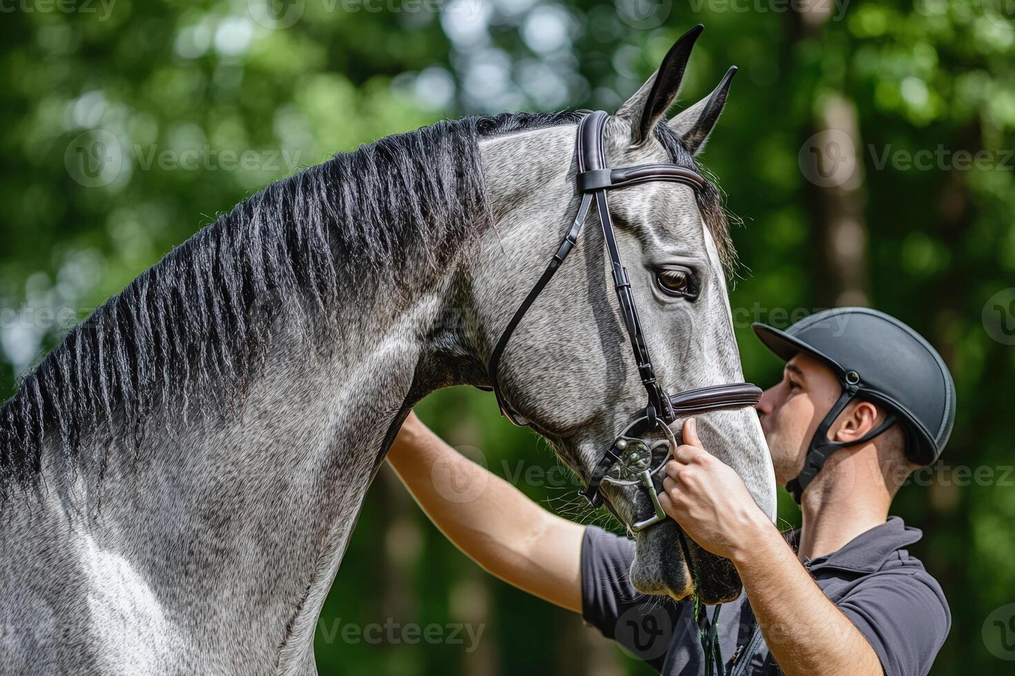 A man is petting a horse with a helmet on photo