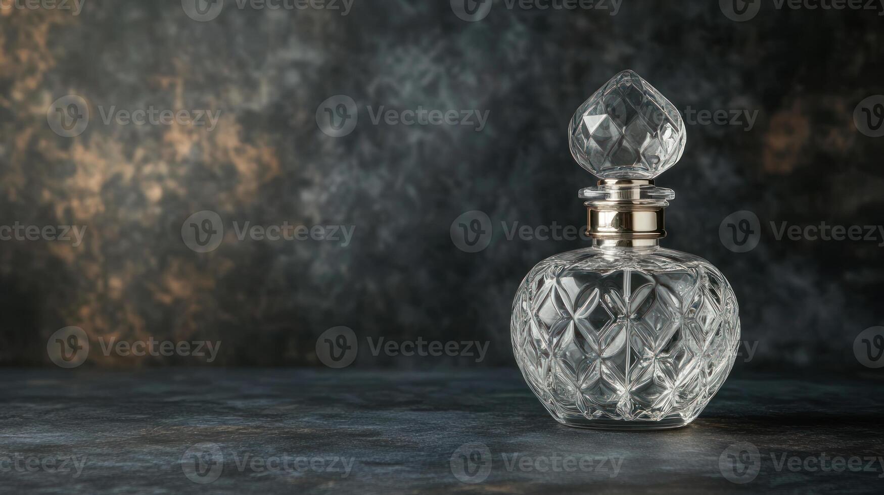 Clear glass perfume bottle on dark background photo