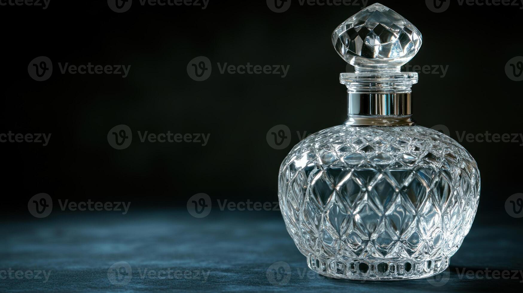 Clear glass bottle on dark surface photo