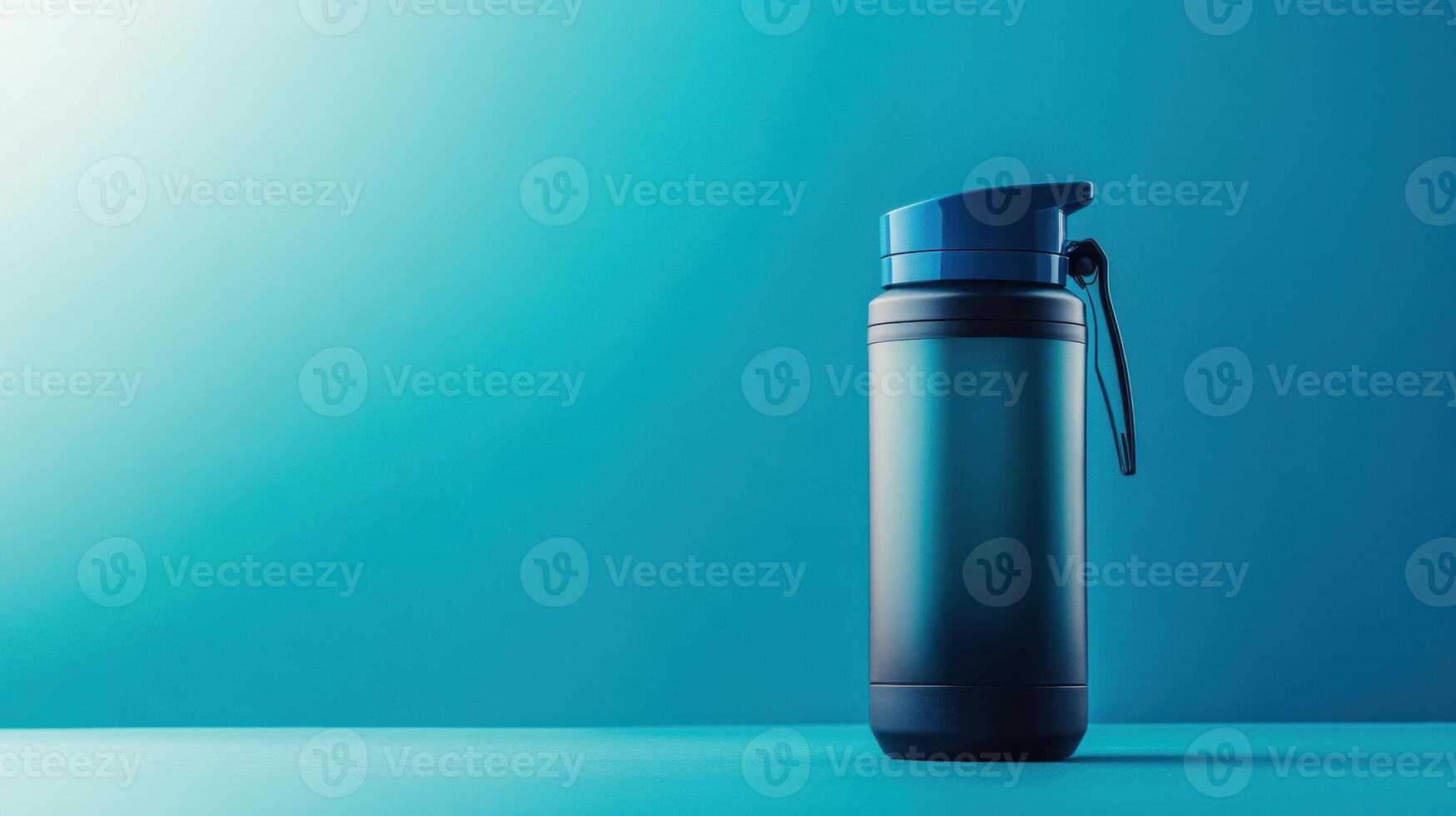 Blue water bottle on a teal background photo