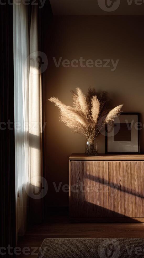 Still life of dried flowers and framed artwork on wooden dresser photo