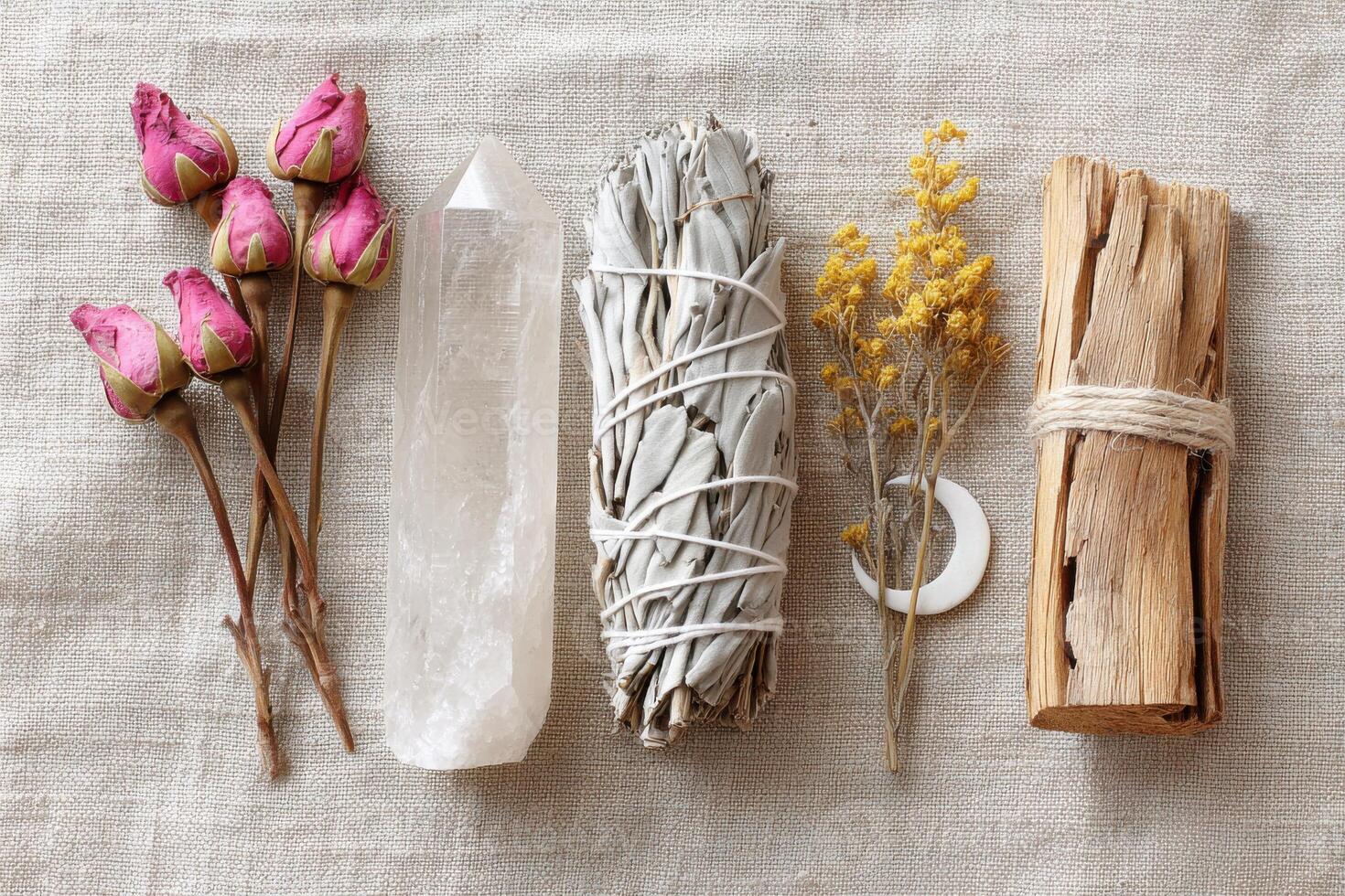 Spiritual flat lay composition with dried flowers, clear quartz, white sage, palo santo and moon pendant photo