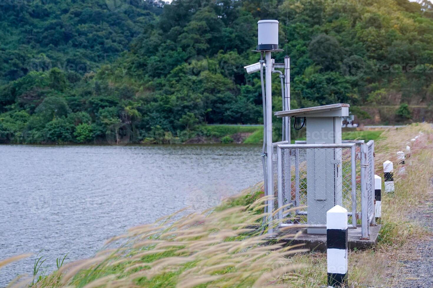 Solar automatic water metering station or water level meter used to measure the water level of a reservoir to help alert villagers to watch out for flooding if the flood level reaches the meter. photo