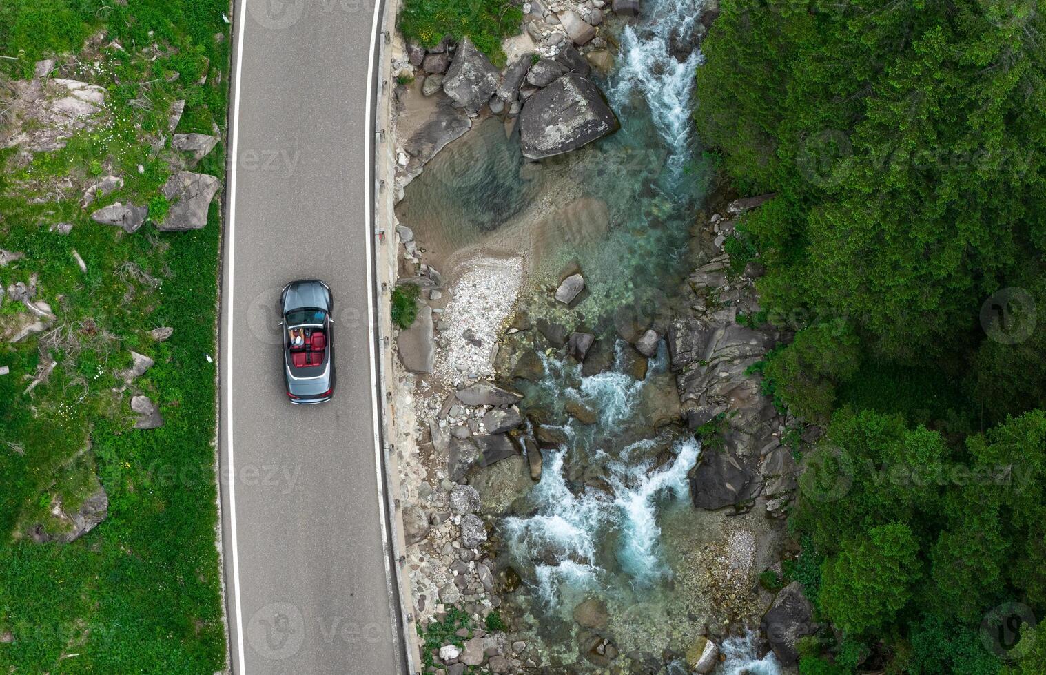 Drive Along a Scenic River With Lush Greenery in the Background During Daylight Hours photo