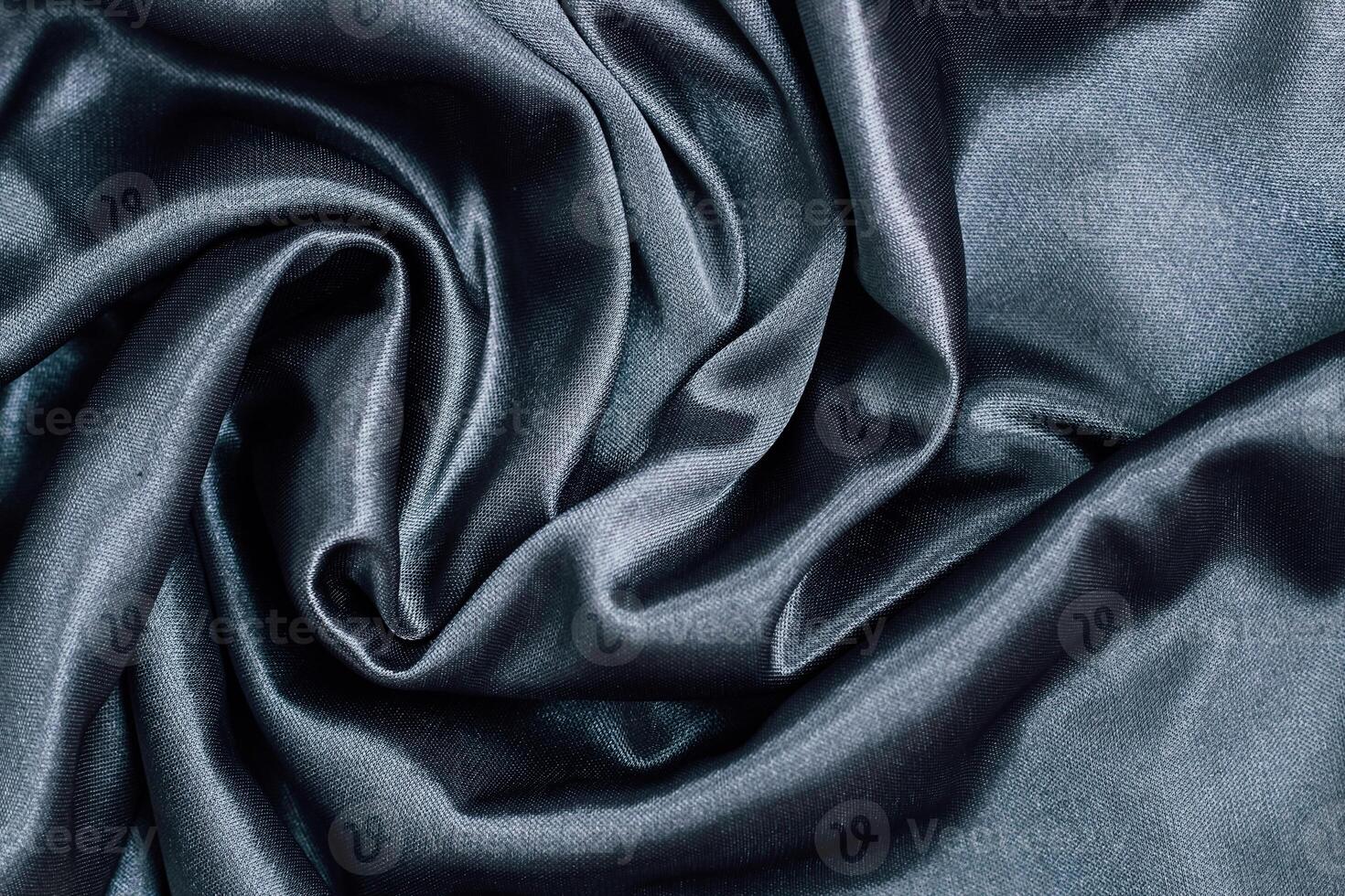 Luxurious dark silk fabric draped elegantly with smooth textures for fashion applications photo