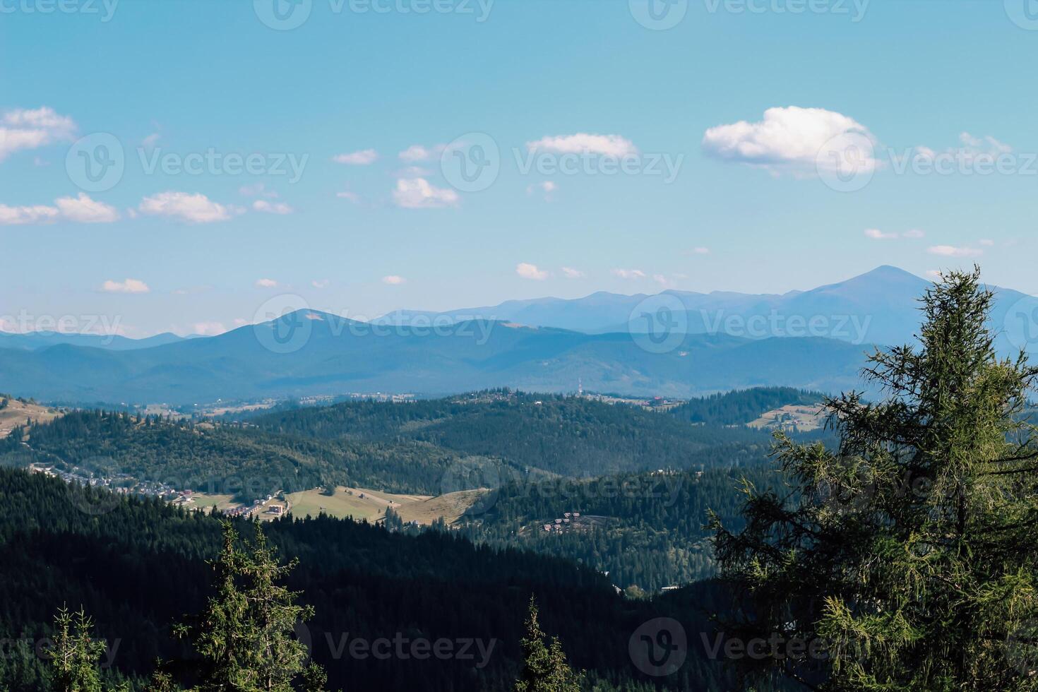 Vast Carpathians mountain landscape with rolling hills and blue sky in mid-afternoon light photo