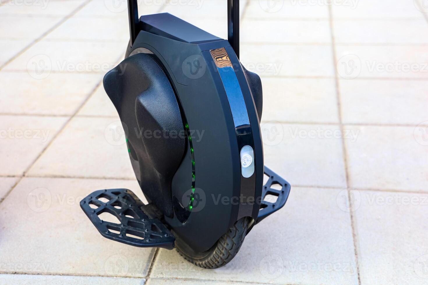 Modern electric unicycle parked on concrete pavement in bright daylight photo
