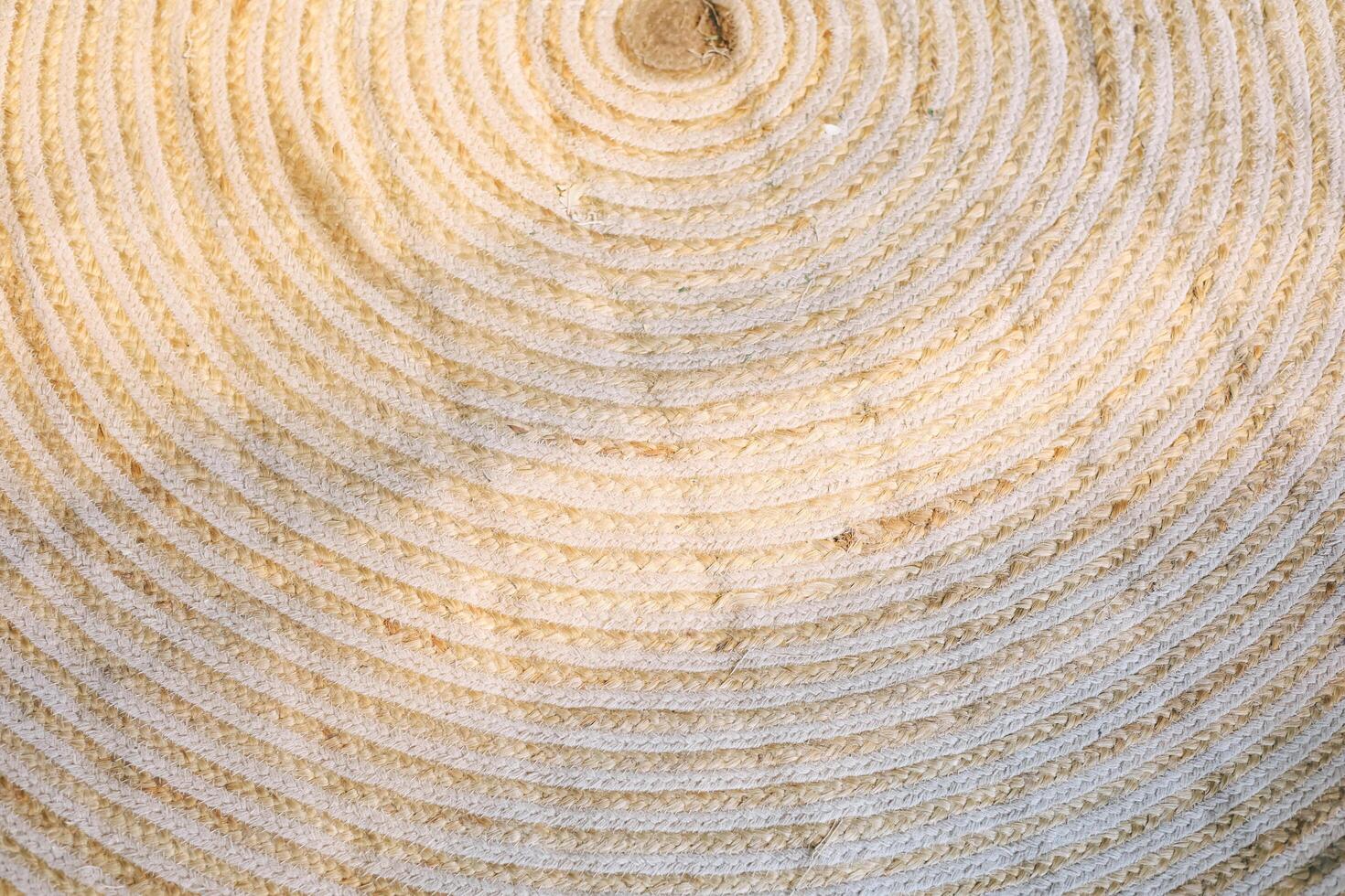 Textured woven surface showing intricate circular patterns from natural fibers photo