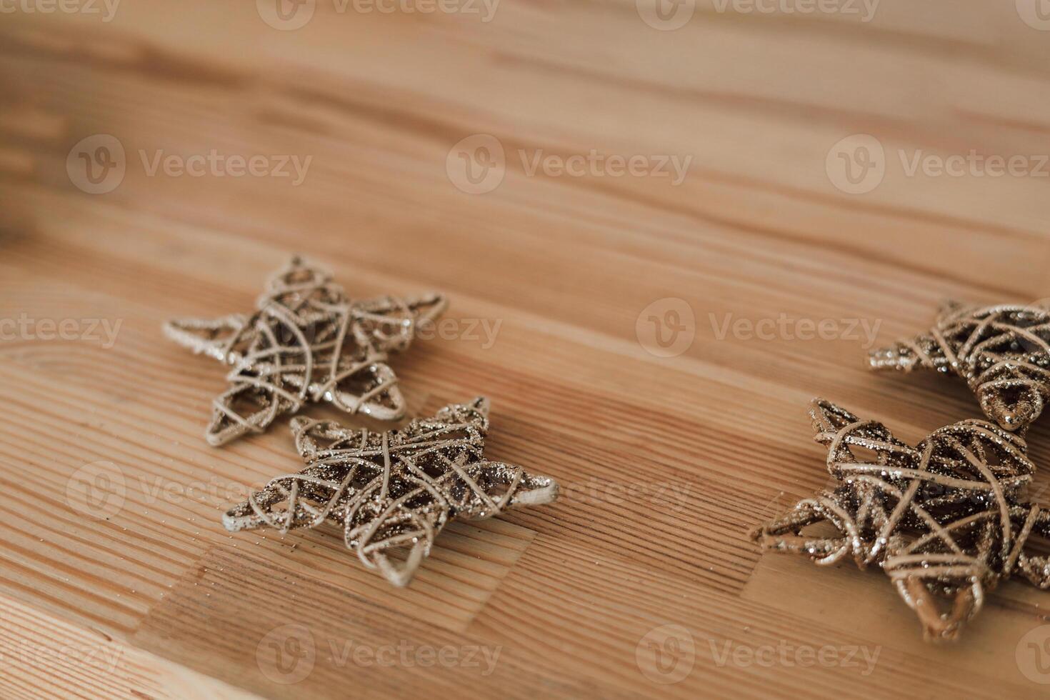 Decorative golden stars arranged on a wooden surface for festive decor in a cozy setting photo