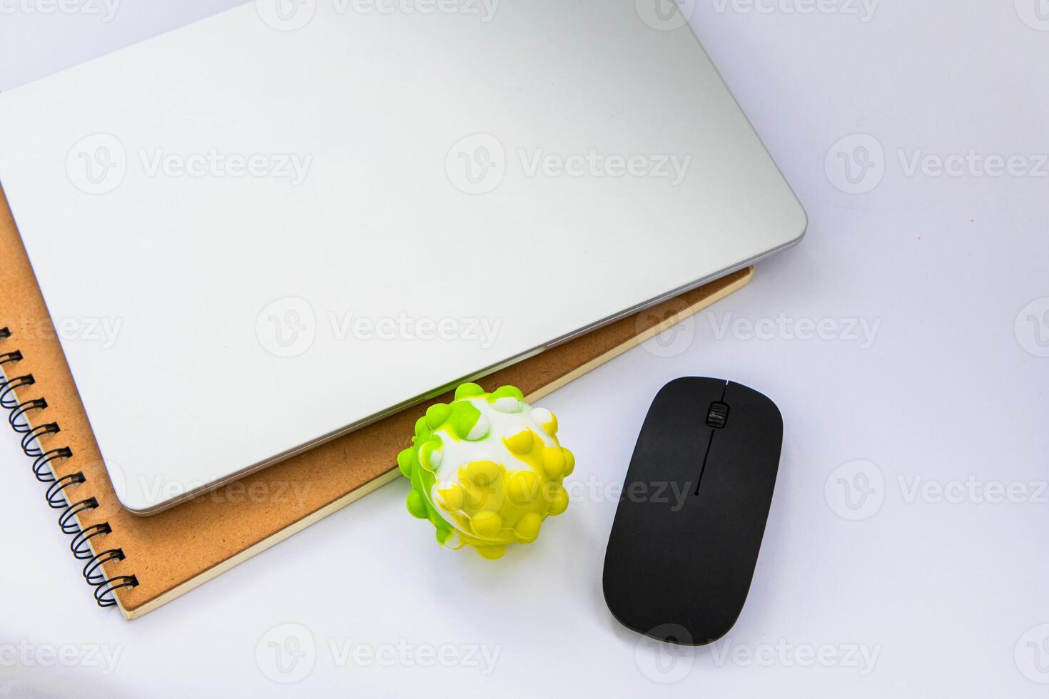 Desk setup with laptop notebook and toy anti-stress for creative workspace inspiration photo