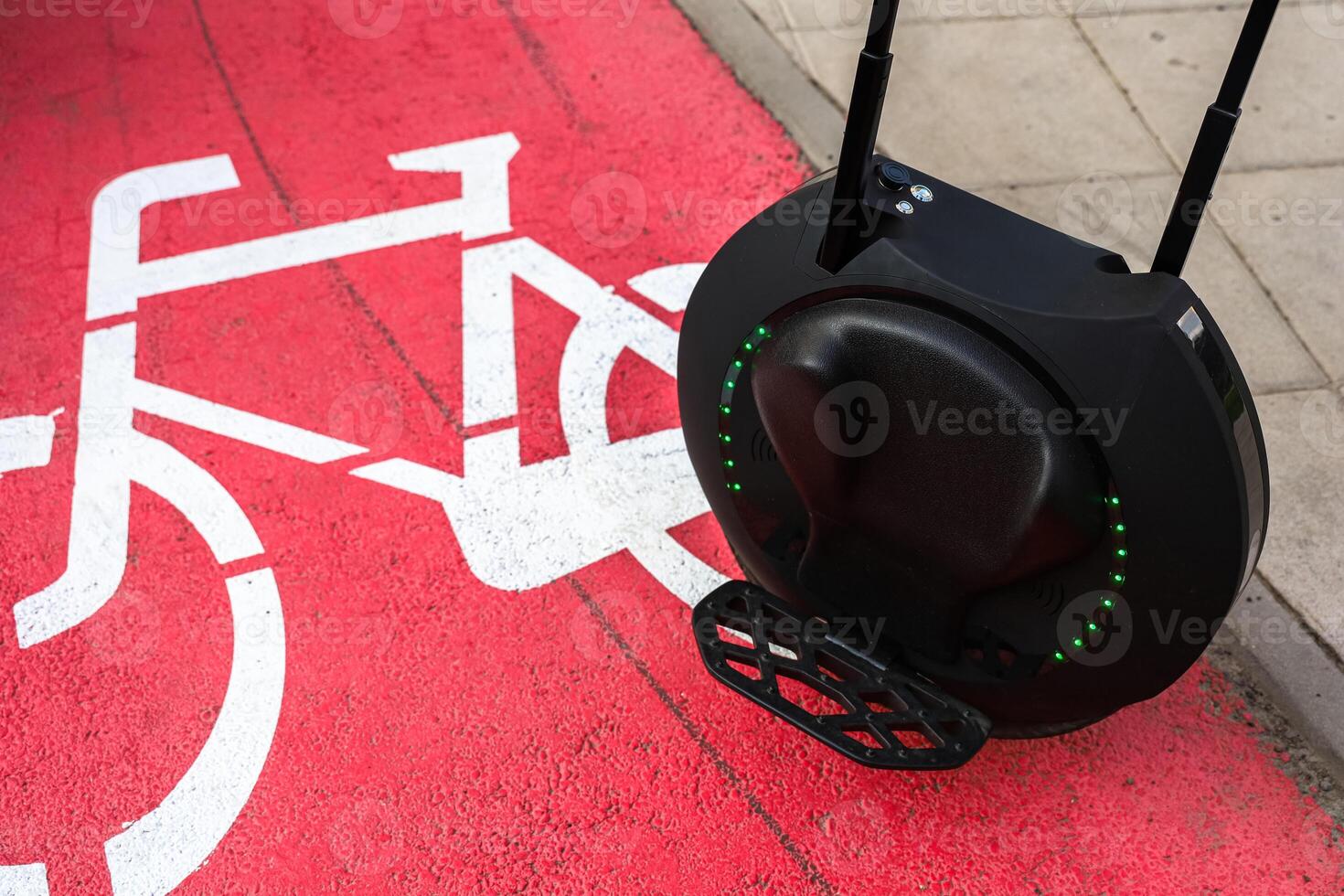 Modern unicycle on bike path in urban setting during daylight photo