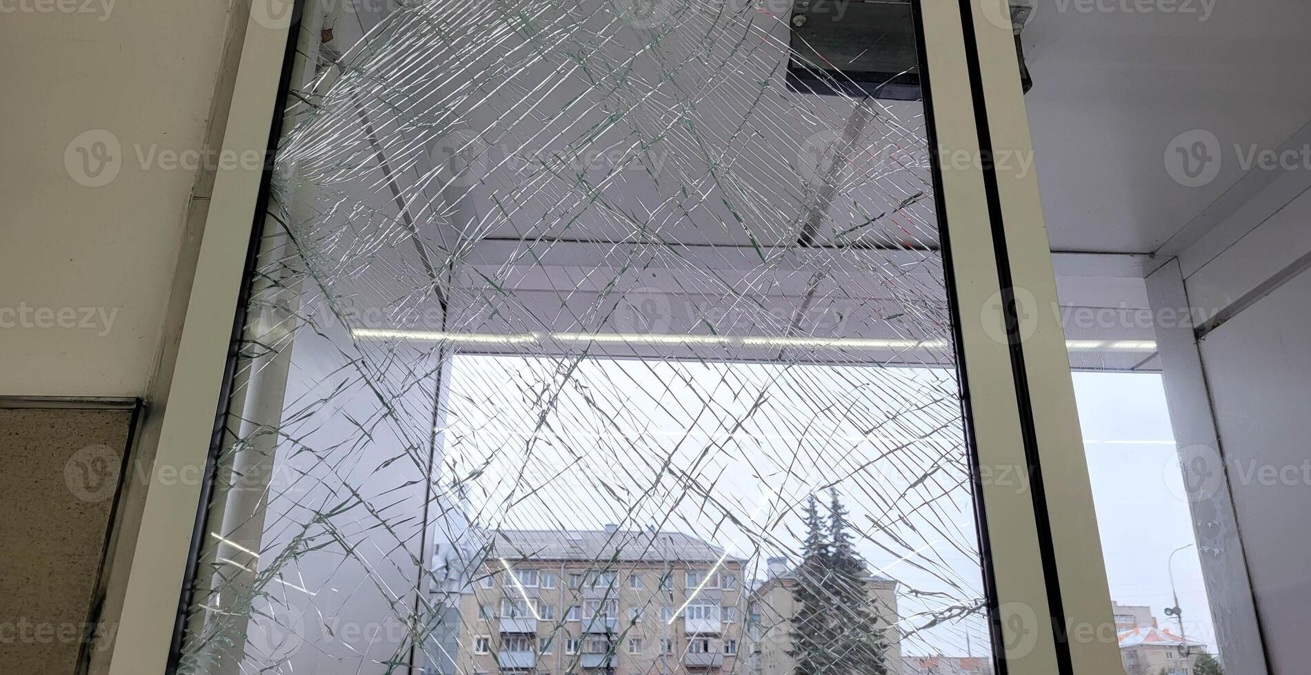 Broken glass in the front doors of the store. photo