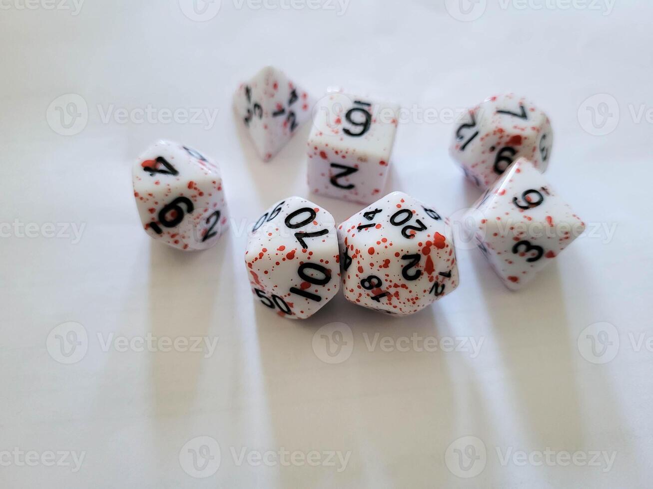 A collection of various multi-faceted game white cubes with numbers photo