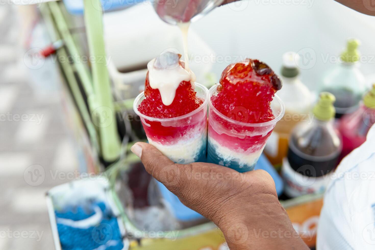 Street vendor preparing colorful local street food dessert photo