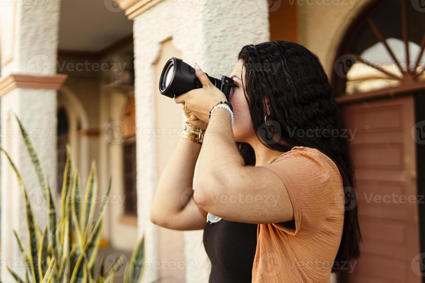 Photographer taking pictures in a latin american town during sunset photo