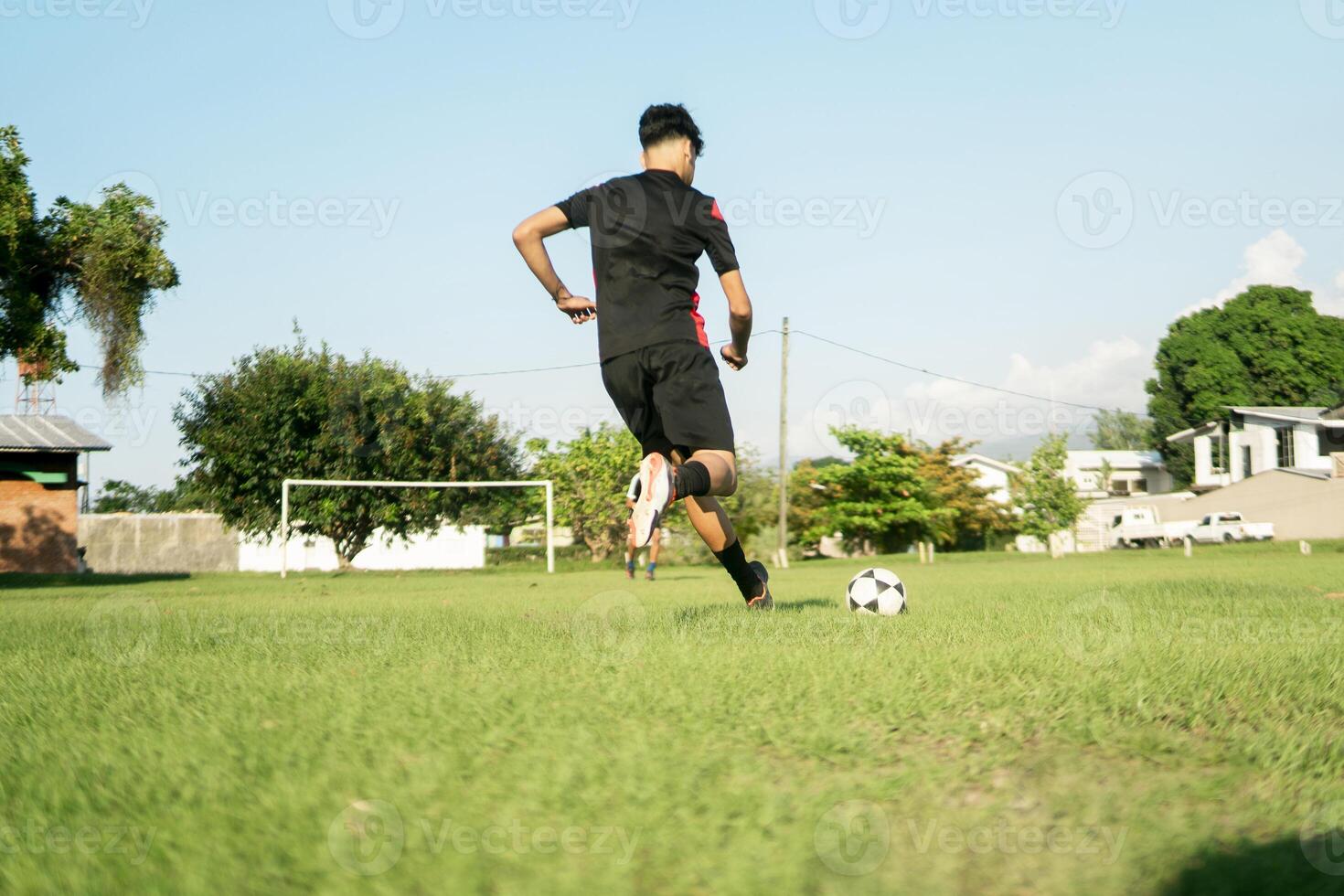 Latin american soccer player dribbling ball on field showing skill and dedication photo