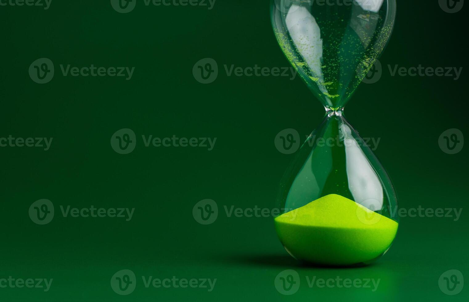 Hourglass stops time of work and life. Process and rules of limited. photo