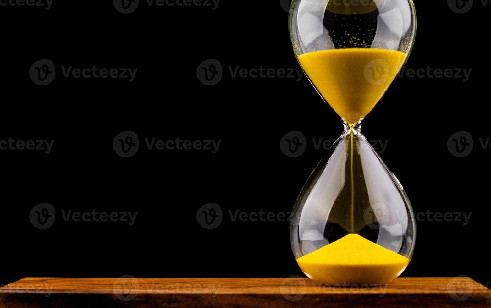 Hourglass stops time of work and life. Process and rules of limited time. Hourglass photo
