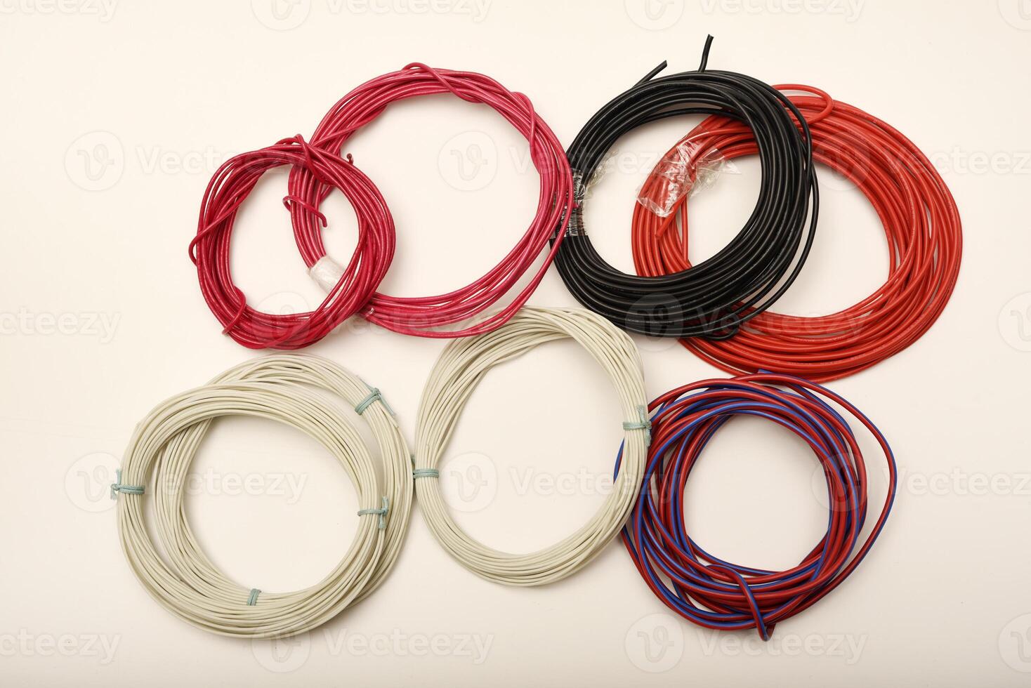 Hand holding a bundle of colorful cables. Bundles of copper connecting wires in rubber insulation. Multicolored wires. photo