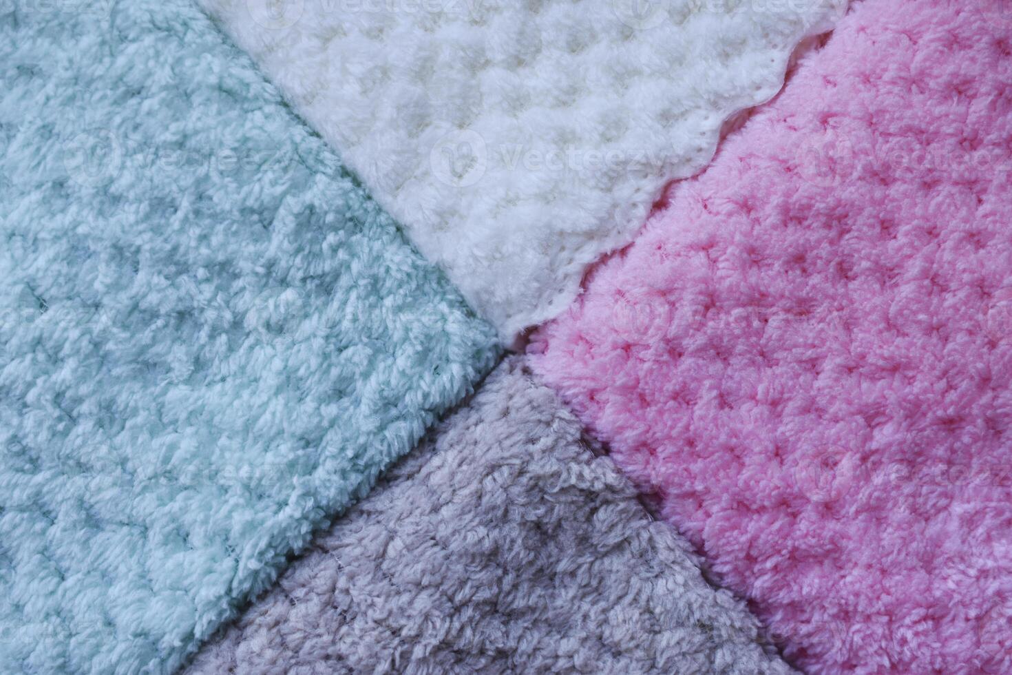 Close-up of fluffy towel texture. Background of colorful towels. Several soft terry towels. photo