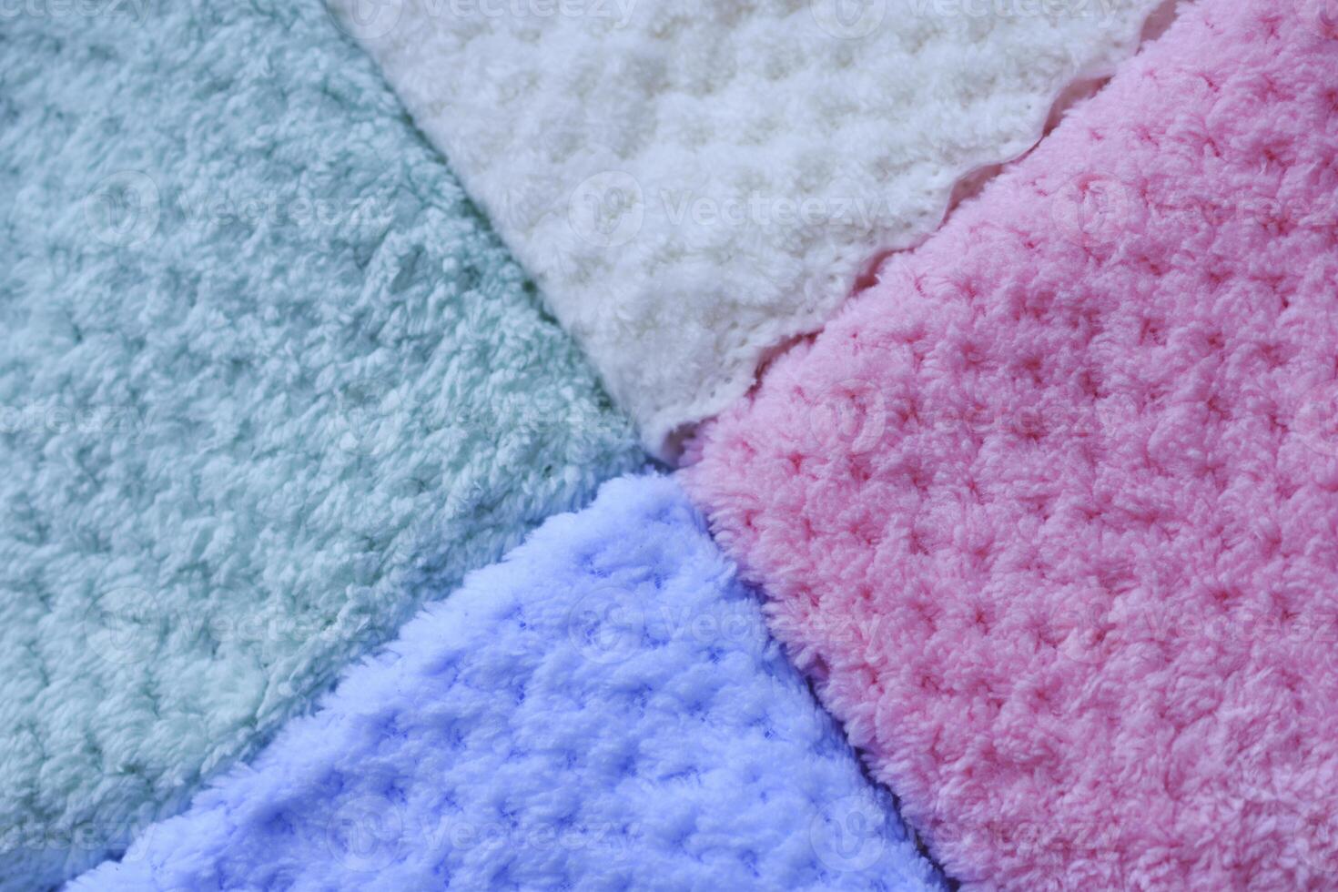 Colorful towels on white background. Background of colorful towels. Several soft terry towels. photo