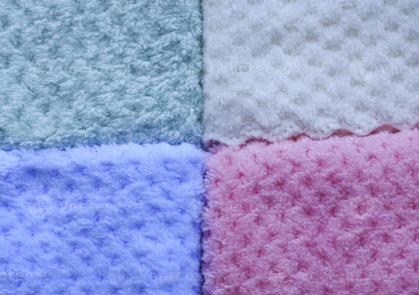 Tropical-print towels on a lounger. Background of colorful towels. Several soft terry towels. photo