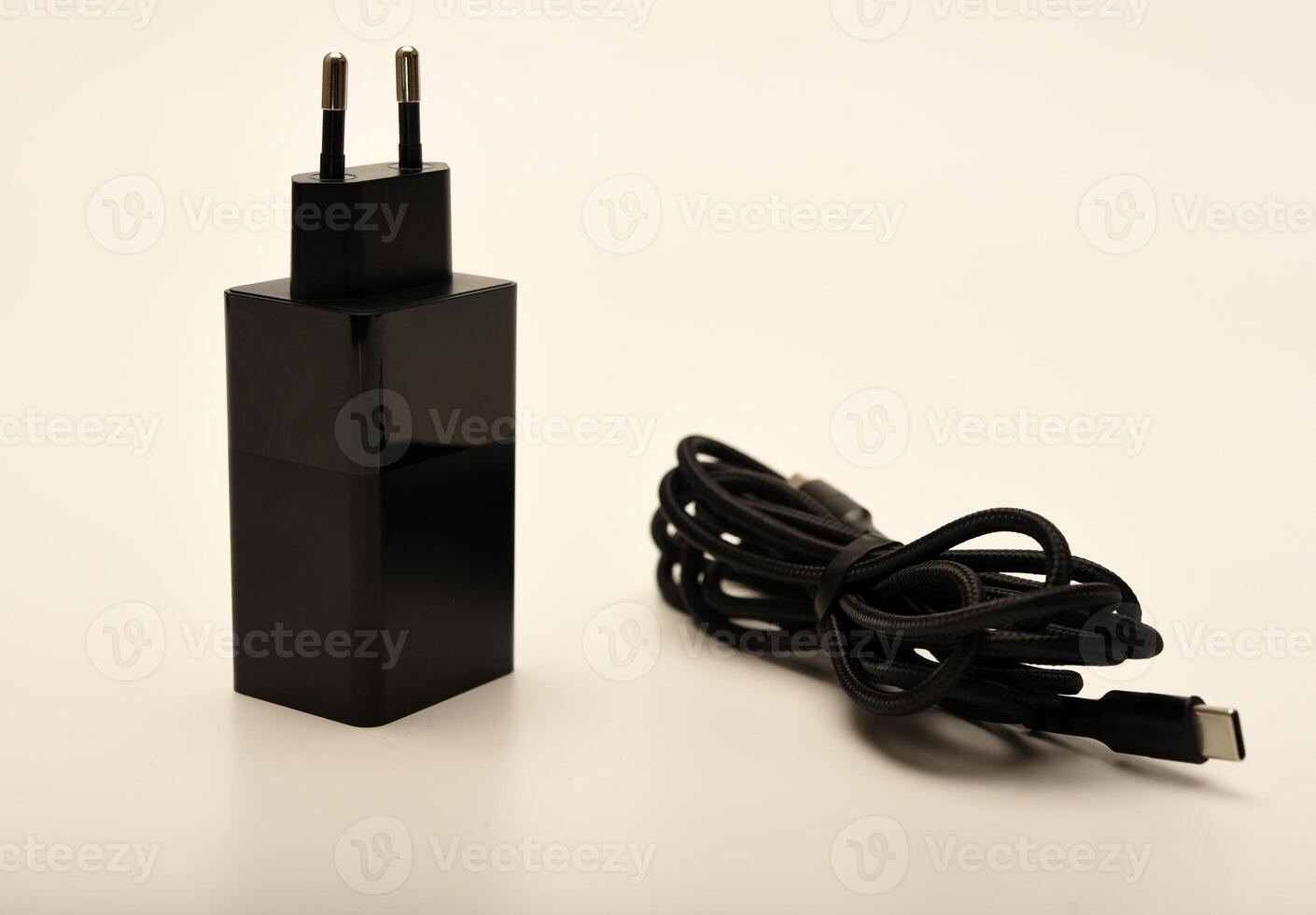 Black wall charger with USB port. A new charger for gadgets with a wire. USB charging with a wire. photo