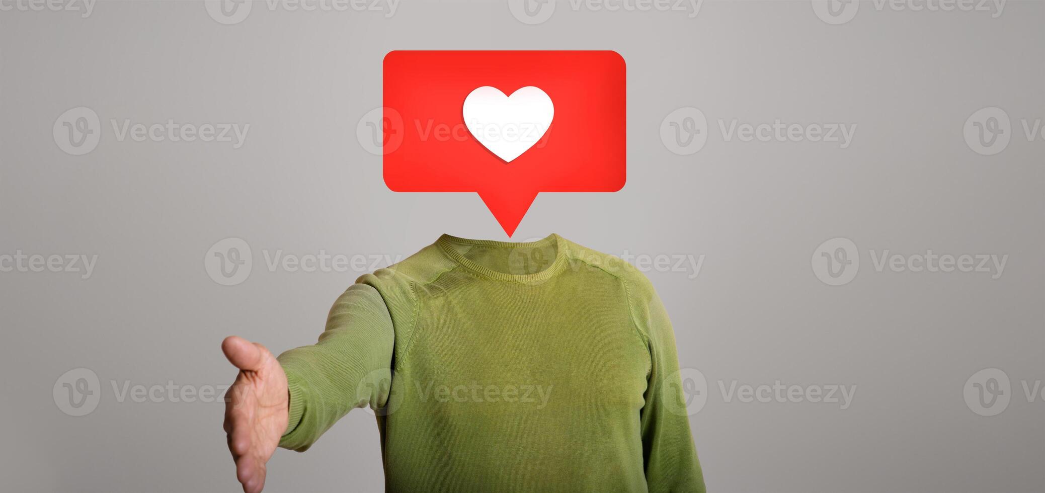 A person reaches out with a hand for a virtual handshake. Above their head is a speech bubble with a heart icon, symbolizing social media interactions and connections in the digital age. photo