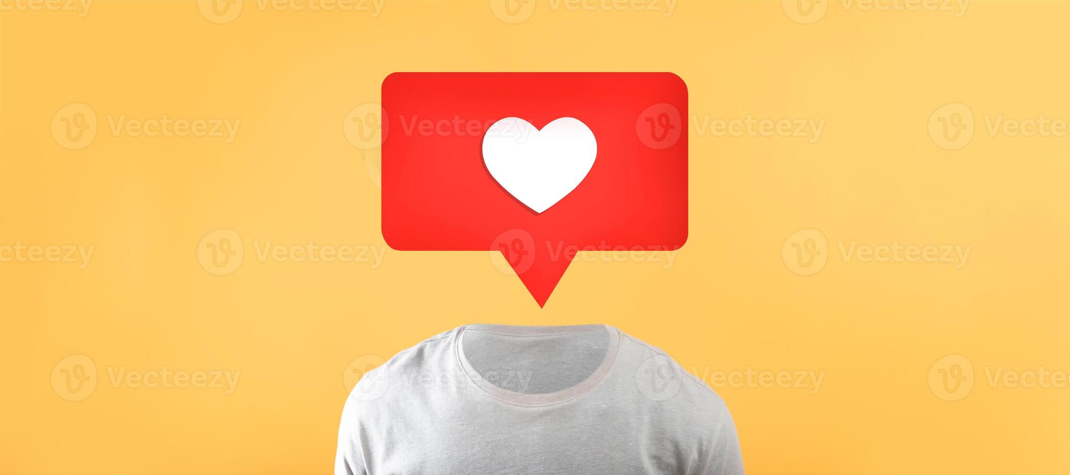 A unique representation showcases a torso in a plain shirt with a red speech bubble above it. The speech bubble contains a white heart symbol, emphasizing social media connections and engagement. photo