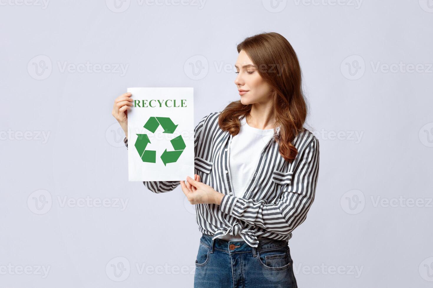 Motivational Placard With Green Recycle Sign In Hands Of Young Woman. Millennial Eco-Friendly Lady Agitating For Waste Sorting And Recycling While Standing Over Grey Studio Background, Copy Space photo