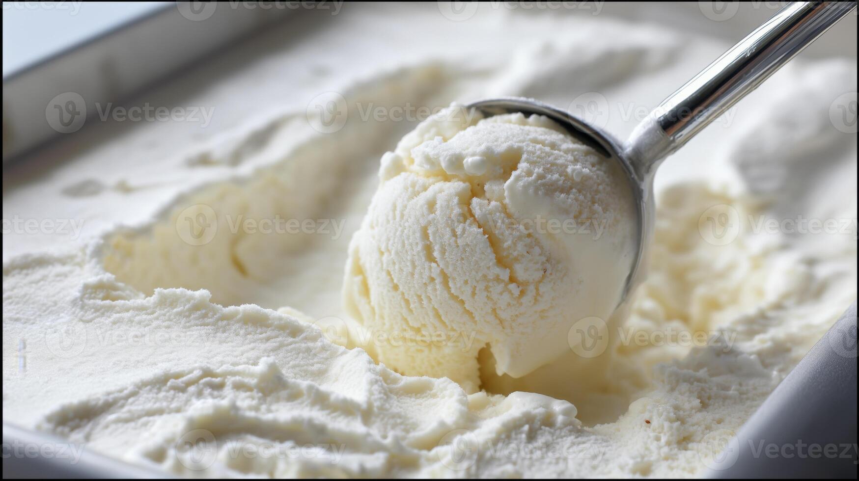 A scoop of creamy vanilla ice cream is lifted from a container, showcasing its smooth texture. photo