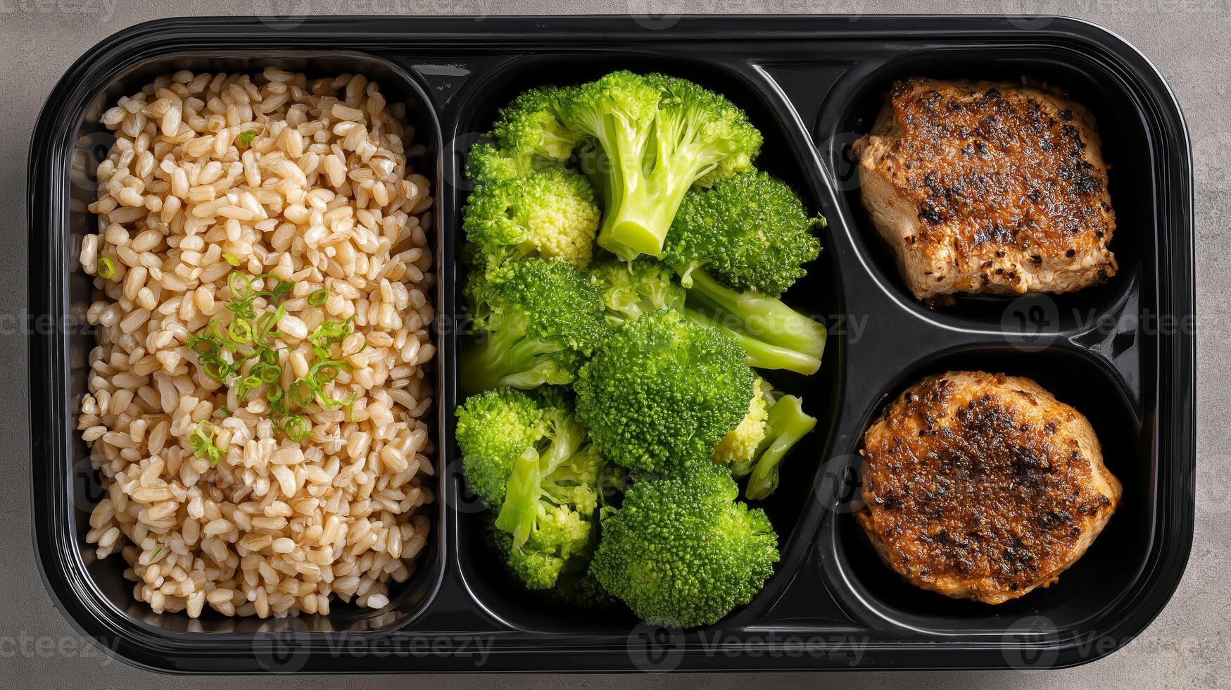 Delicious and nutritious meal featuring brown rice, broccoli, and grilled chicken served in a tray. photo