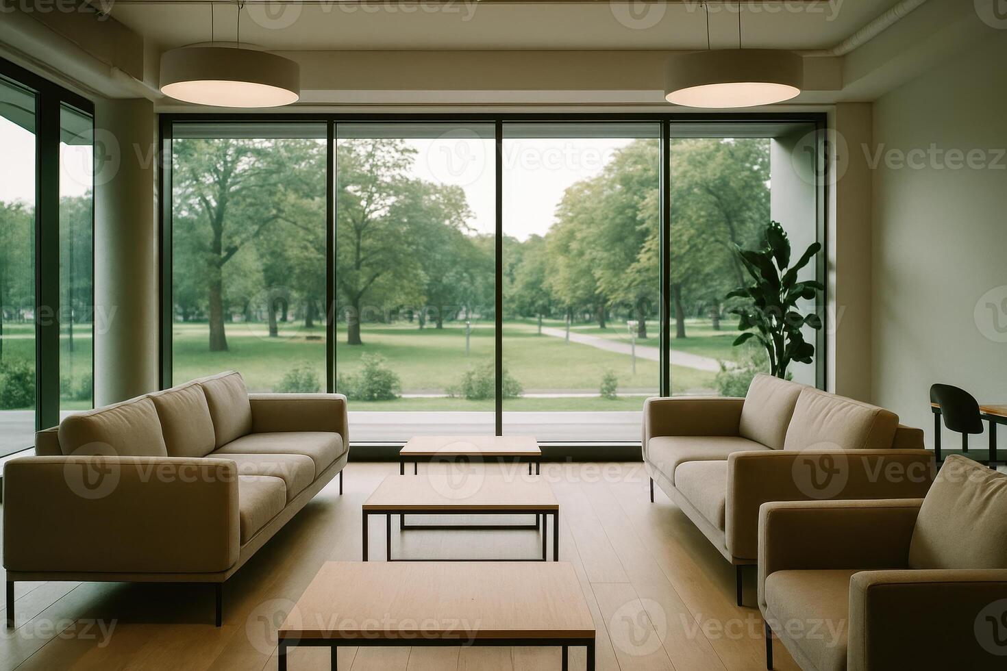 Modern co working space common area with comfortable sofas and tables overlooking a green park photo