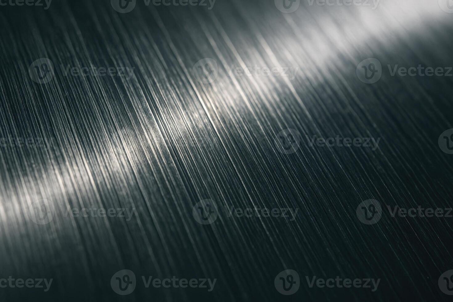 Textured brushed metal surface with fine vertical lines and light reflection photo