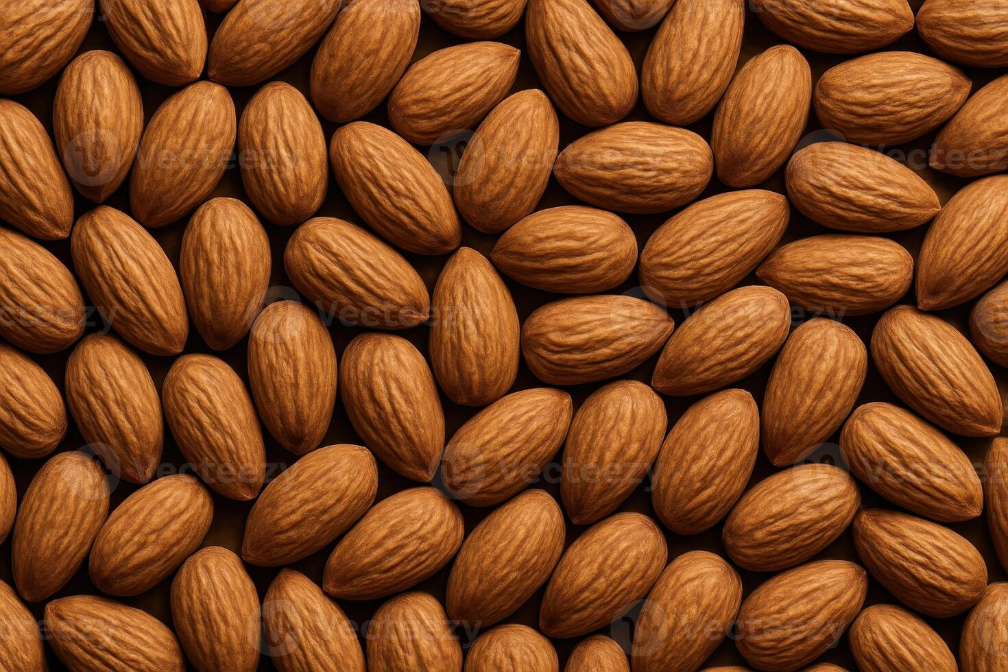 Natural unshelled almonds tightly packed together forming a rustic textured full frame background photo