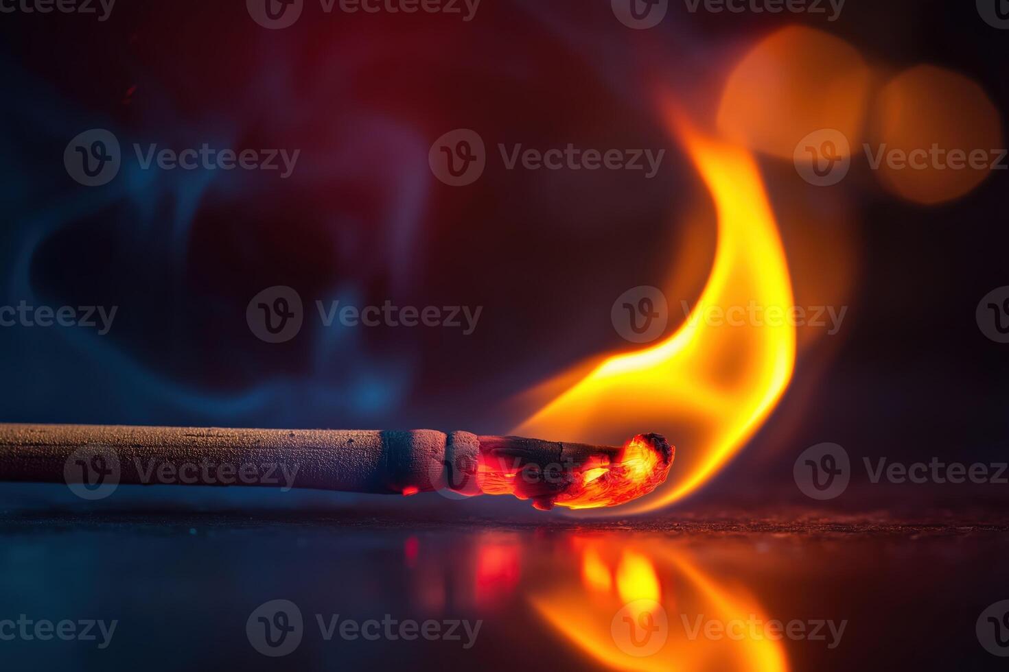 Burning match with smoke and orange flames creating warmth photo