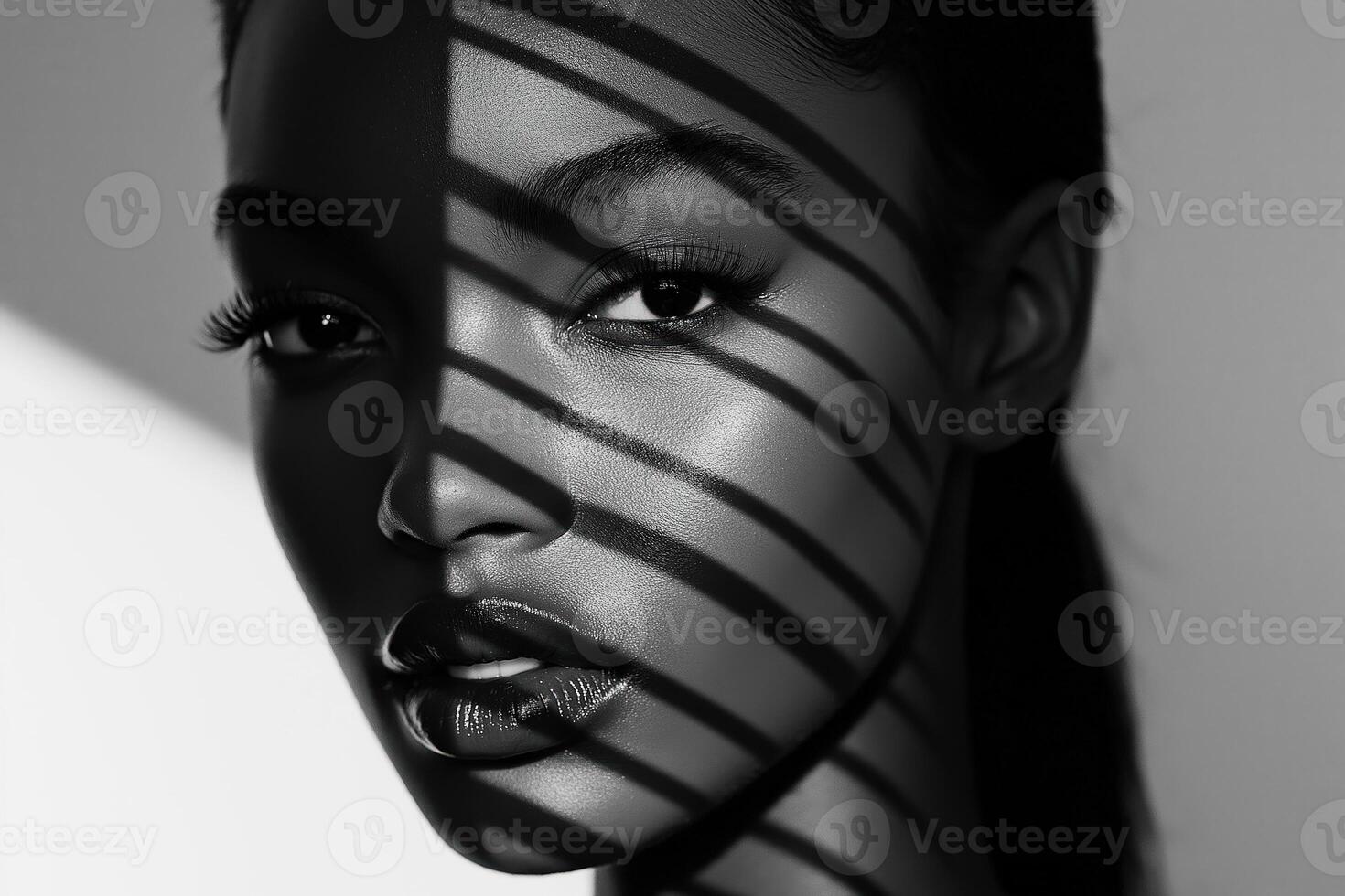 Fashion model posing with striped shadow on face photo