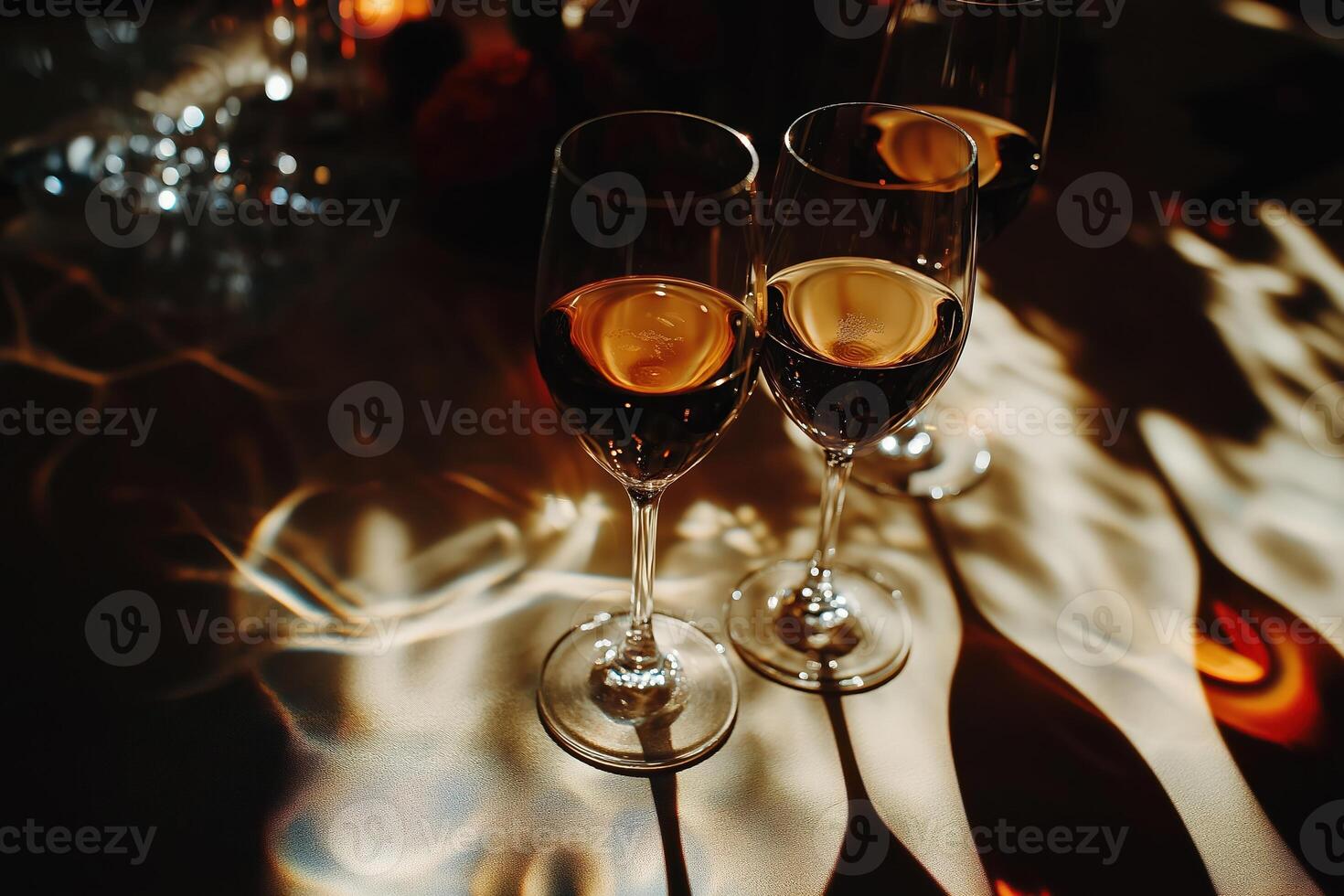 Wine glasses reflecting light on elegant table setting photo