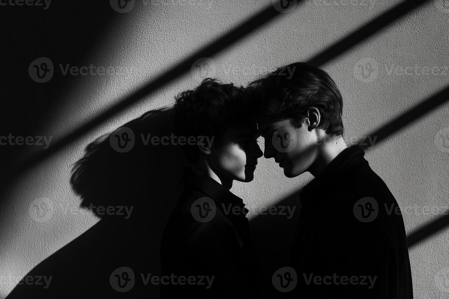 Young couple sharing intimate moment in dramatic lighting photo