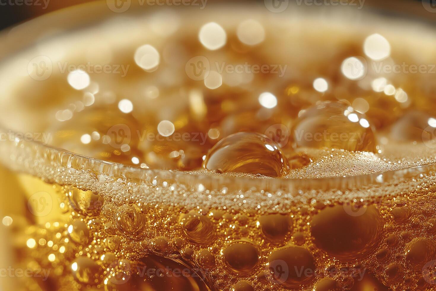 Close-up of golden bubbles rising in a glass of sparkling drink photo