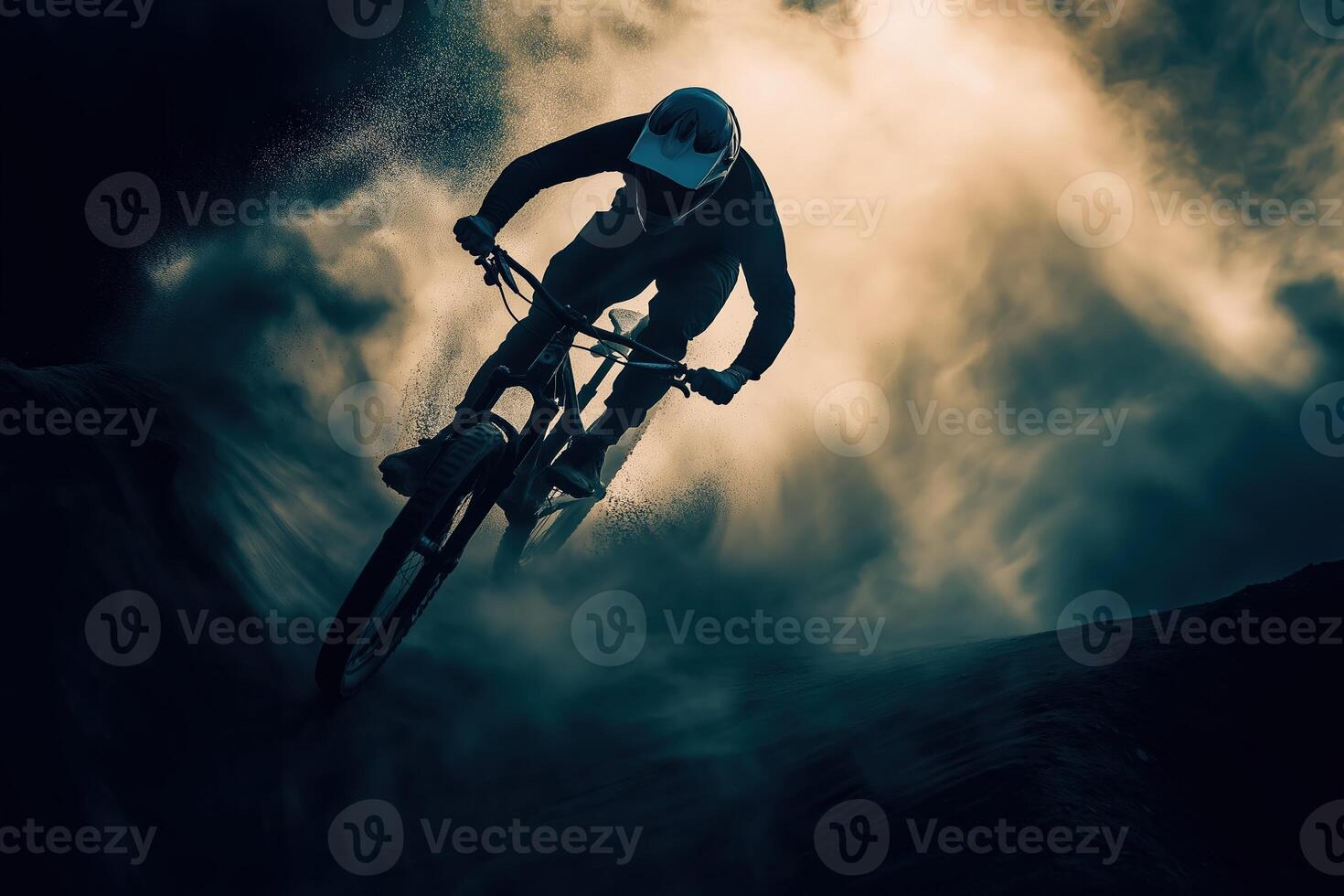 Professional cyclist performing extreme downhill mountain biking in dust cloud photo